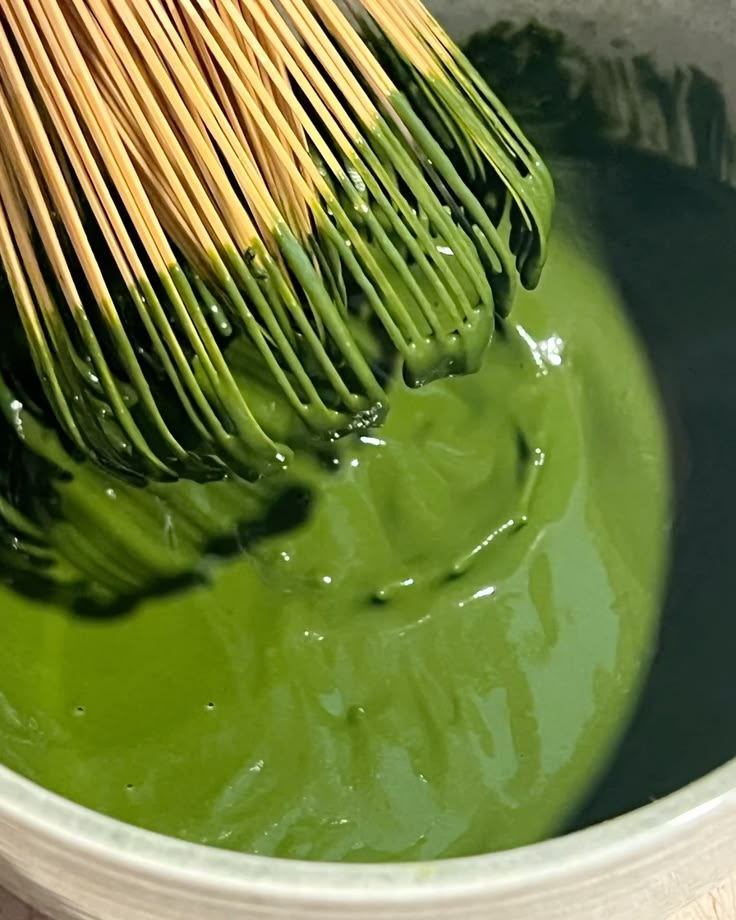 Whisking premium matcha in a bowl